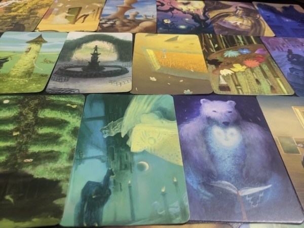 Mysterium vision cards laid out displaying the haunting creativity of the artists.