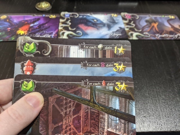A hand of cards in Tides of Madness, shows three cards in hand, three already on the table, and three madness tokens.